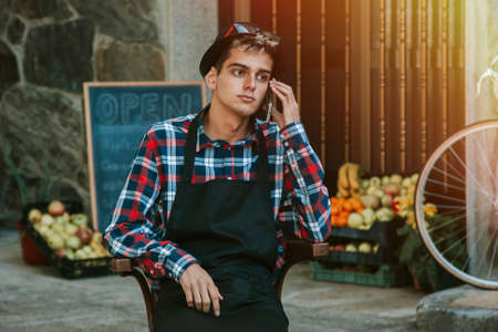 young man talking on mobile phone in your businessの写真素材