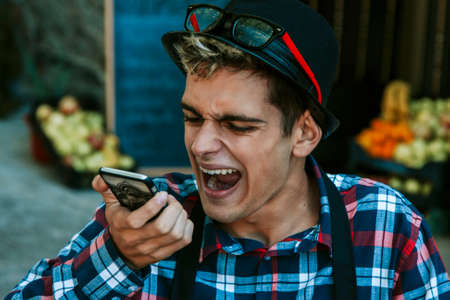 businessman screaming on the mobile phoneの写真素材