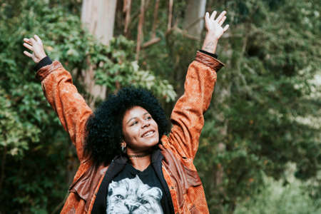young woman smiling happily in the forest outdoorの写真素材