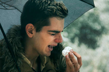 terrified man with handkerchief sneezing, fluの写真素材