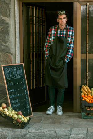 young man working in his small food businessの写真素材