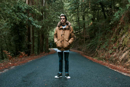 young man on the mountain road in autumnの写真素材