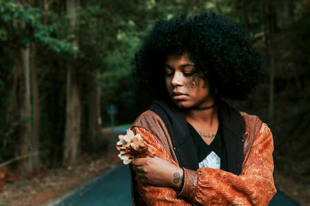 woman with autumn leaves outdoorsの写真素材