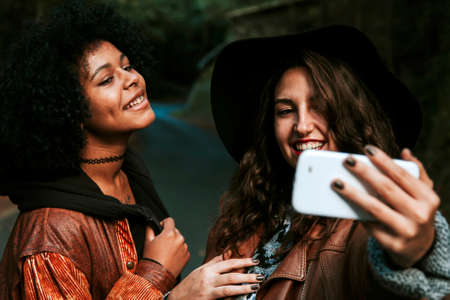 friends with mobile phone taking picturesの写真素材