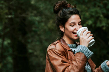 girl with cup of coffee on the street, fast foodの写真素材