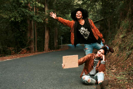 girl hitchhiking with posterの写真素材