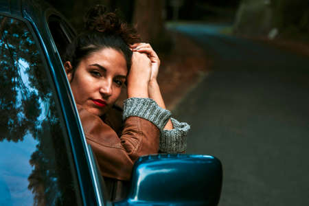 enjoying girl in the car on the roadの写真素材