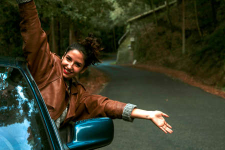 enjoying girl in the car on the roadの写真素材