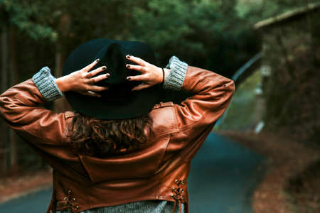 woman holding the hat backの写真素材