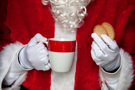 santa claus having coffee with cookiesの写真素材