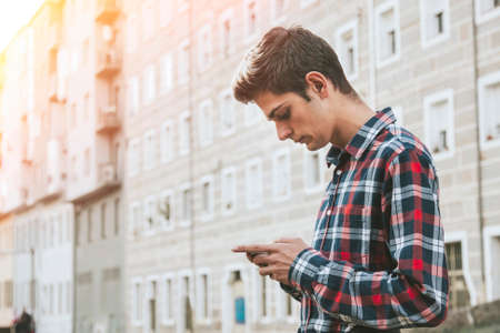 young man with mobile phone in the cityの写真素材