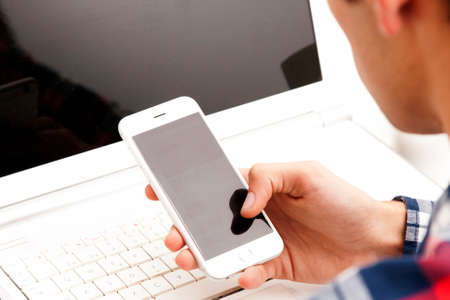 hands with mobile phone and computer