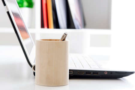 pen and laptop in the officeの写真素材