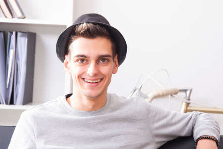 portrait of attractive young man at home smiling