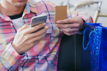 hands mobile phone and credit card, online shoppingの写真素材