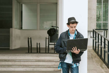 young teen in the university with the laptopの写真素材