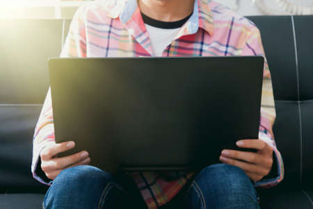 man with the computer in the living room of homeの写真素材
