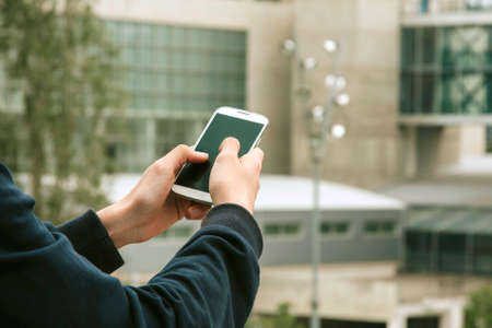 hands with phone mobile in the city