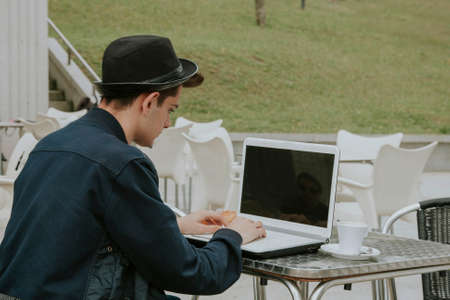student with the laptop in the coffee shopの写真素材