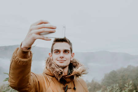 young making a picture with the phone mobileの写真素材