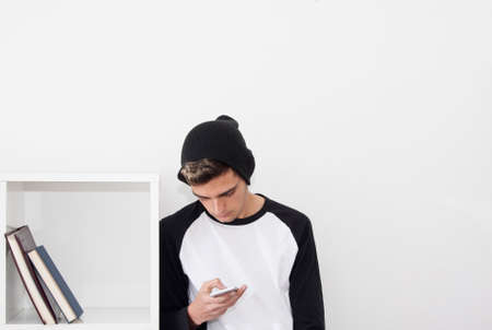 young man with the phone at home and vintage bicycle, technology and lifestyleの写真素材