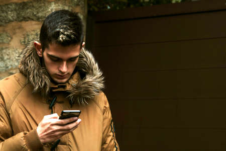 man with mobile phone and outerwearの写真素材