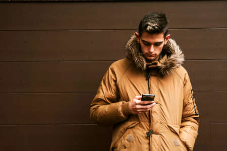 man with mobile phone and outerwearの写真素材