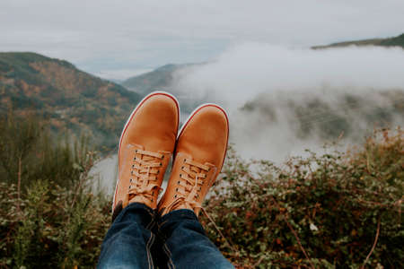 boots in the foreground on the panoramic view of the Valley, concept of adventure and travelの写真素材