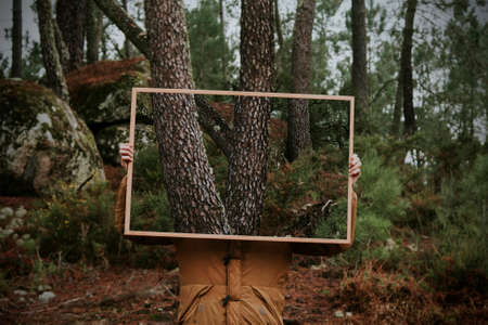 young holding frame with nature, concept of environmentの写真素材