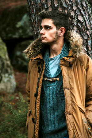 young posing in the forest with jeans and casual man