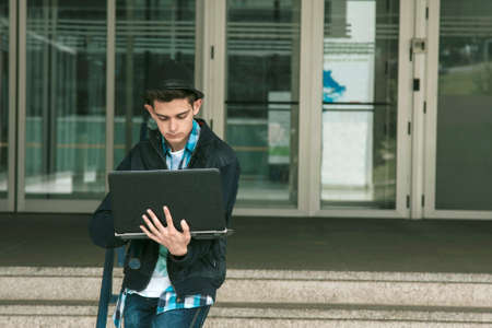 young teen in the university with the laptopの写真素材