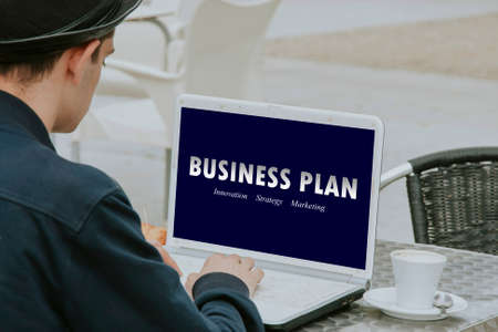 male young looking for plans of business in the computer personalの写真素材
