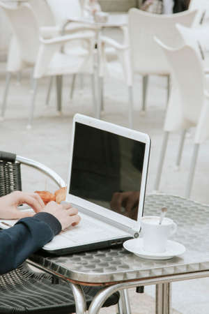 young man with the laptop in the coffee shopの写真素材