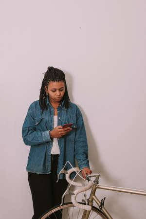 girl young's style casual with the phone mobile in the wall white