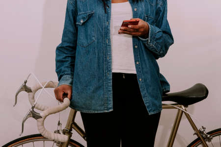 closeup of the hands of the girl young with jeans with the phone mobileの写真素材