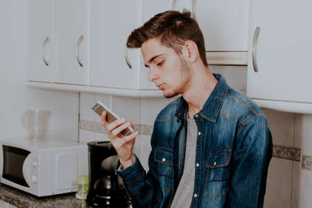 male young's style casual with the telephone phone in the apartmentの写真素材