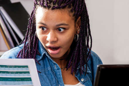 young woman looking scared expenseの写真素材