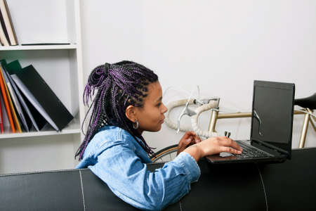 young woman of style casual with the computer laptop in the living room of Houseの写真素材