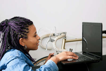 young woman of style casual with the computer laptop in the living room of Houseの写真素材