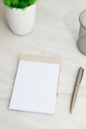 block of notes on the desktop with the pen, space for text and messagesの写真素材