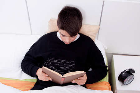 child in bed reading a book