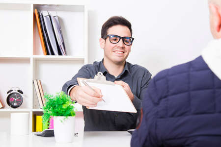 businessman in office picking up the signature of the customer