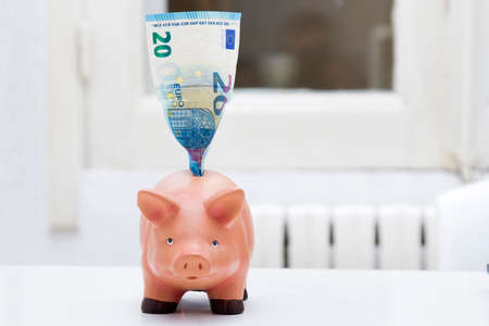 piggy bank with the ticket of euro, concept of savingsの写真素材
