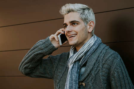 teen young man to fashion on the phone mobile outdoor