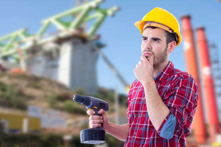 professional of the building thoughtful with the drillの写真素材