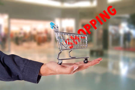 hand with the shopping cart and shopping textの写真素材