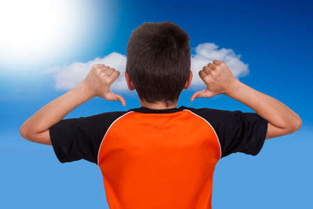 child pointing hands back of shirtの写真素材