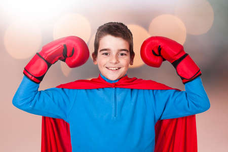 child superhero costume and expression of strength and powerの写真素材