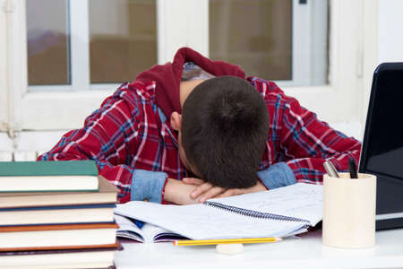 child tired and stressed at the school desk