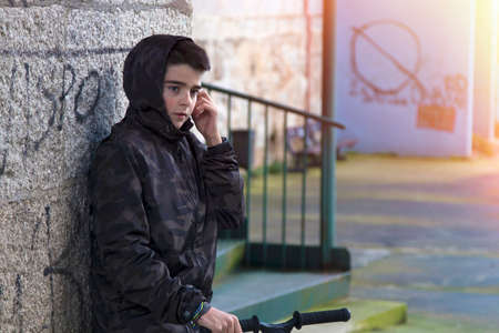 child in the street of the city with the scooter